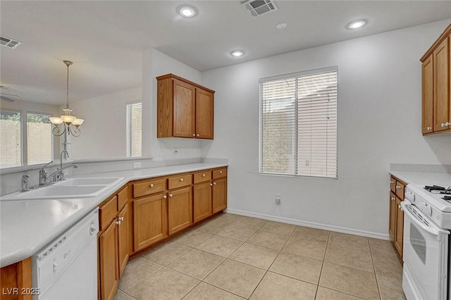 kitchen with white appliances, light tile patterned flooring, hanging light fixtures, and sink