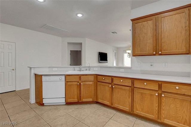 kitchen featuring sink, dishwasher, light tile patterned flooring, and kitchen peninsula