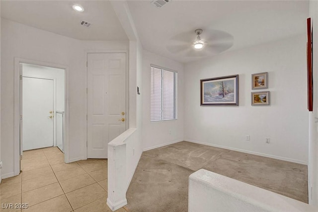 entryway with ceiling fan and light tile patterned floors