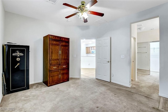 unfurnished bedroom with ceiling fan and light colored carpet