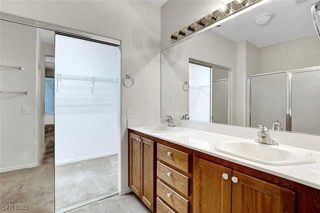 bathroom featuring walk in shower and vanity