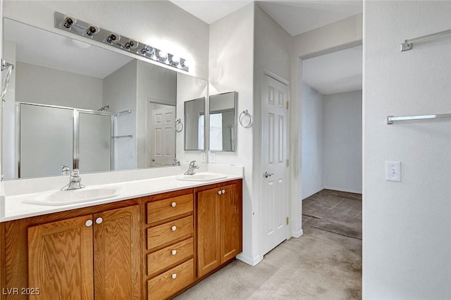 bathroom featuring a shower with door and vanity