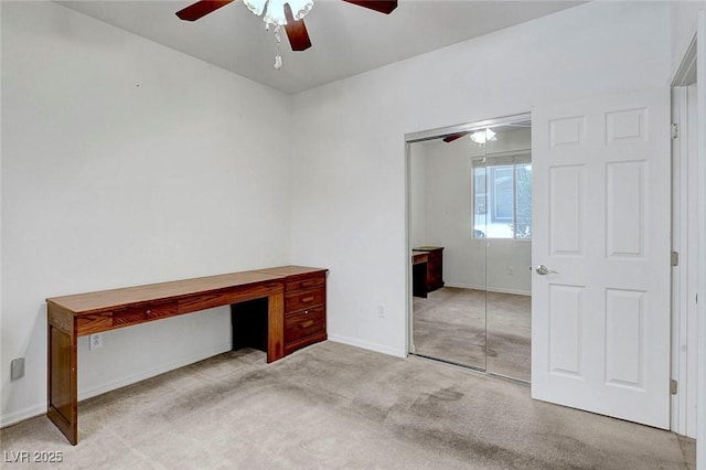 unfurnished bedroom featuring ceiling fan, a closet, and light carpet