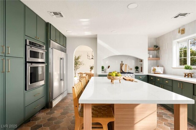 kitchen featuring green cabinetry and stainless steel appliances