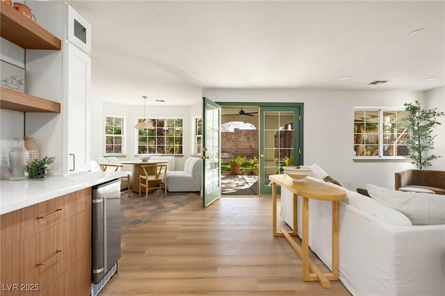 living area featuring visible vents and light wood-type flooring