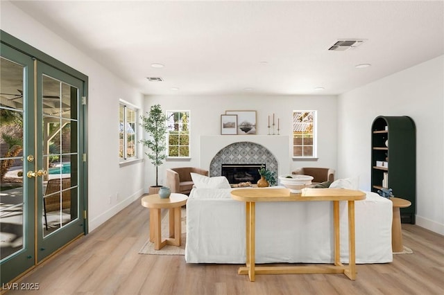 living room with light hardwood / wood-style flooring and french doors