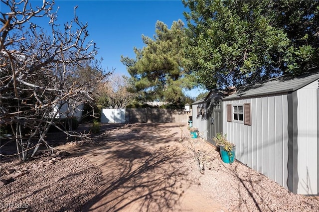 view of yard featuring an outbuilding and a fenced backyard