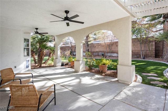 view of patio / terrace with a ceiling fan and fence