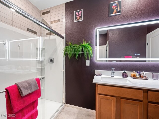 bathroom with an enclosed shower and vanity