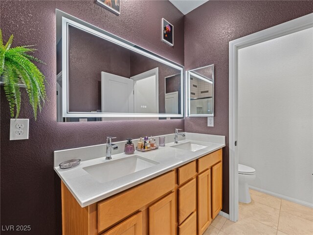 bathroom with toilet, tile patterned flooring, and vanity