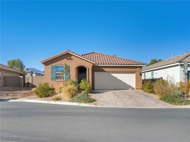 mediterranean / spanish-style house with a garage