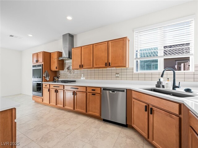 kitchen with stainless steel appliances, wall chimney range hood, backsplash, light tile patterned flooring, and sink