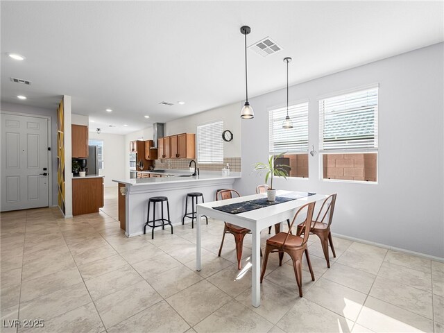 dining space with light tile patterned flooring and sink