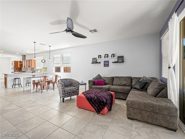 living room with ceiling fan and light tile patterned floors