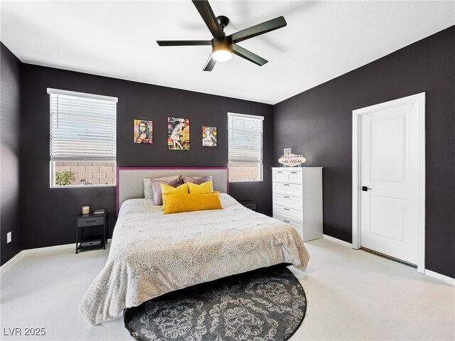 carpeted bedroom with ceiling fan and multiple windows