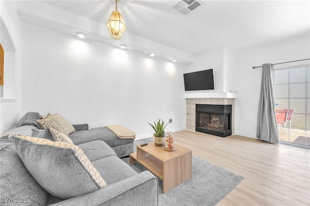 living room featuring a fireplace and hardwood / wood-style flooring