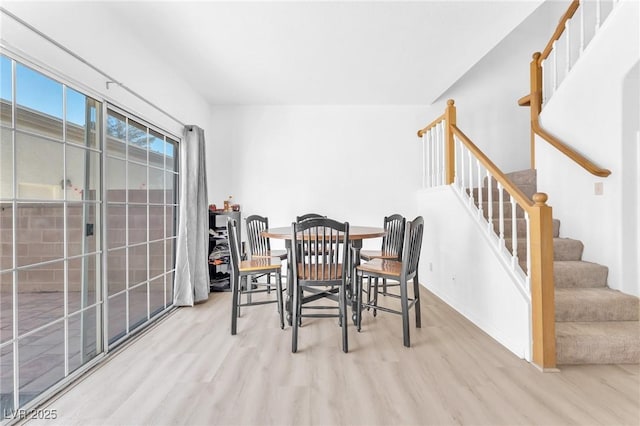 dining space featuring light wood-type flooring