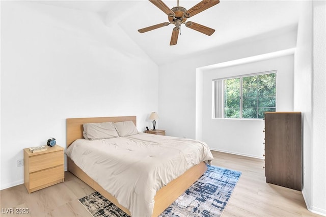 bedroom with ceiling fan, light hardwood / wood-style floors, and lofted ceiling with beams