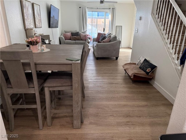 dining area featuring hardwood / wood-style floors and ceiling fan