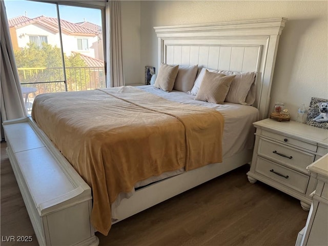 bedroom with access to outside and dark wood-type flooring