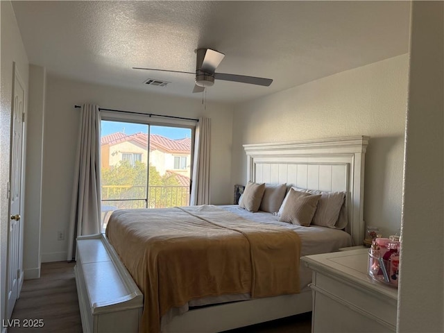 bedroom featuring wood-type flooring, a textured ceiling, and ceiling fan