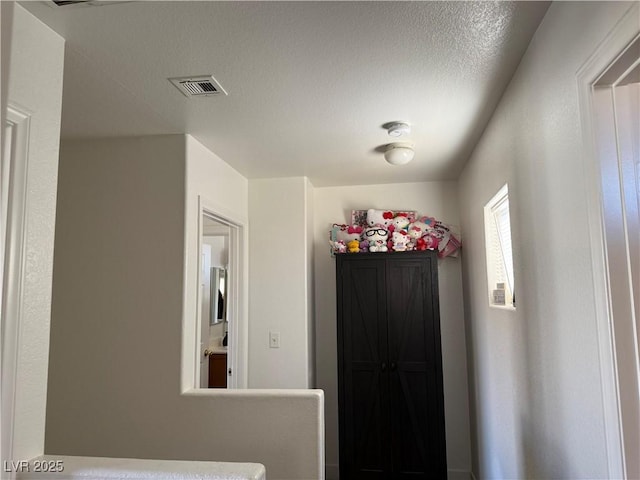 entryway with a textured ceiling