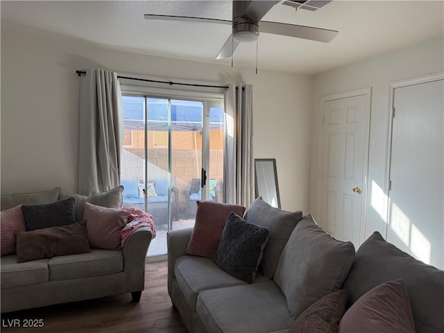 living room with ceiling fan and dark hardwood / wood-style flooring