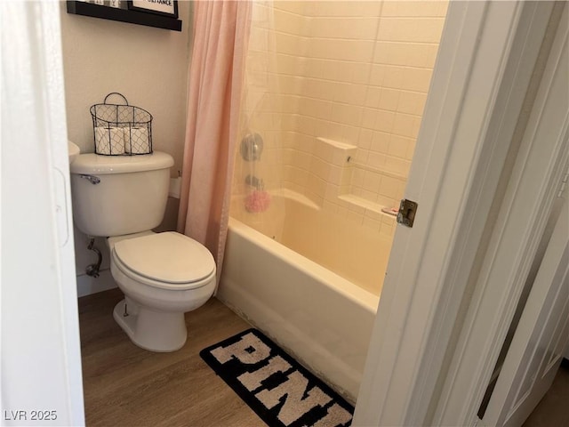 bathroom with toilet, shower / tub combo, and wood-type flooring