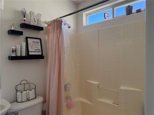 bathroom with toilet and shower / tub combo