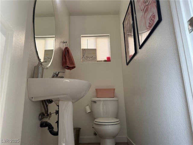 bathroom featuring toilet and sink