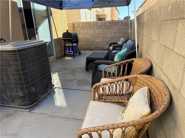 view of patio with central AC and a grill