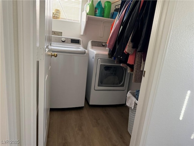 clothes washing area featuring washer and dryer and dark hardwood / wood-style floors