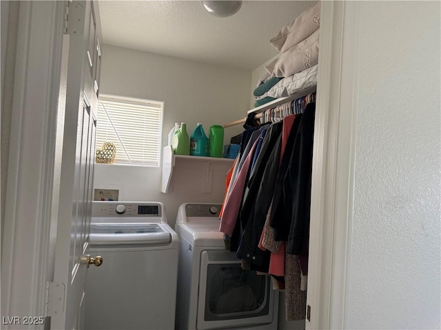 washroom with washing machine and clothes dryer