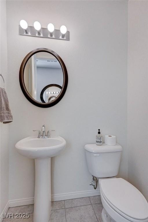 bathroom with toilet and tile patterned flooring