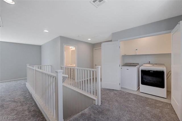 laundry room with light colored carpet and washing machine and dryer