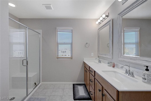 bathroom with an enclosed shower, tile patterned flooring, and vanity