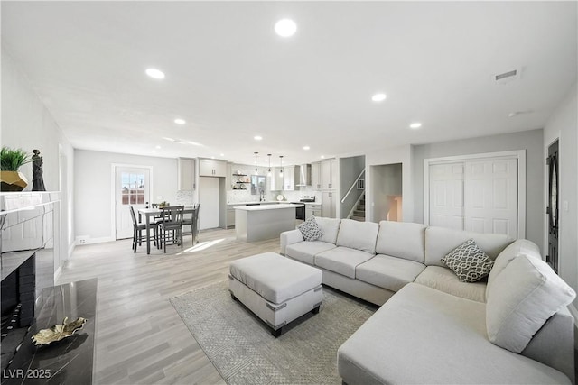 living room with light hardwood / wood-style flooring