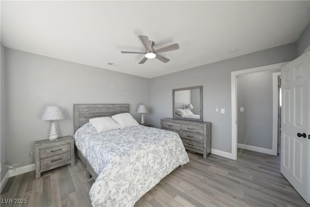 bedroom with ceiling fan and light hardwood / wood-style floors