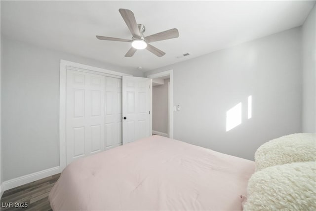 bedroom featuring ceiling fan, a closet, and wood-type flooring