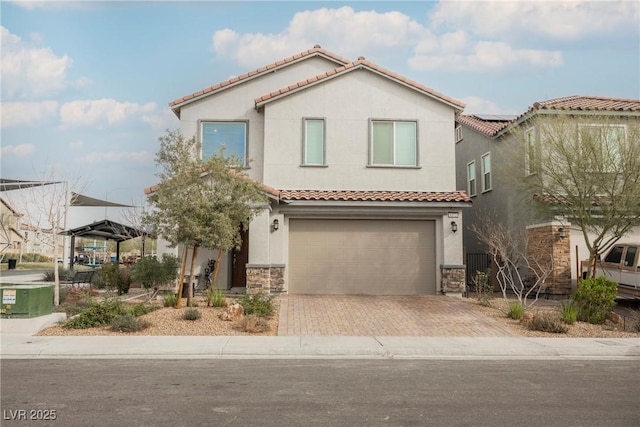 mediterranean / spanish-style house with a garage, solar panels, a tile roof, decorative driveway, and stucco siding