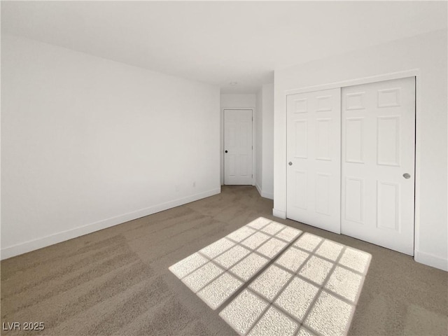 unfurnished bedroom with a closet and carpet flooring