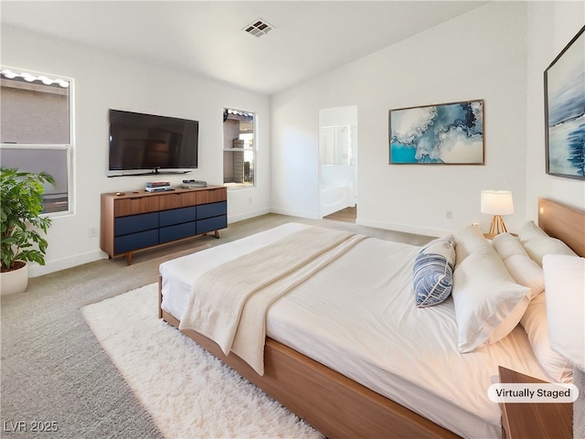 carpeted bedroom with lofted ceiling and connected bathroom