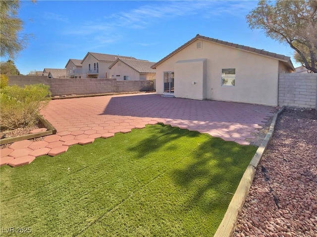 rear view of property featuring a patio area