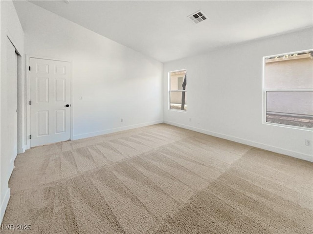 spare room with light colored carpet