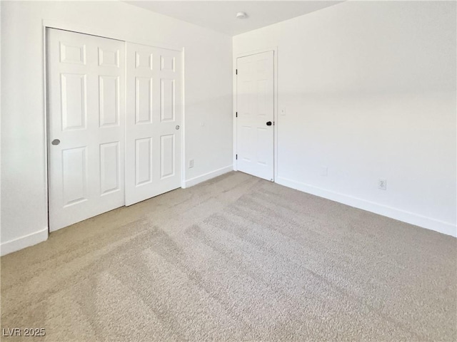 unfurnished bedroom featuring carpet floors and a closet