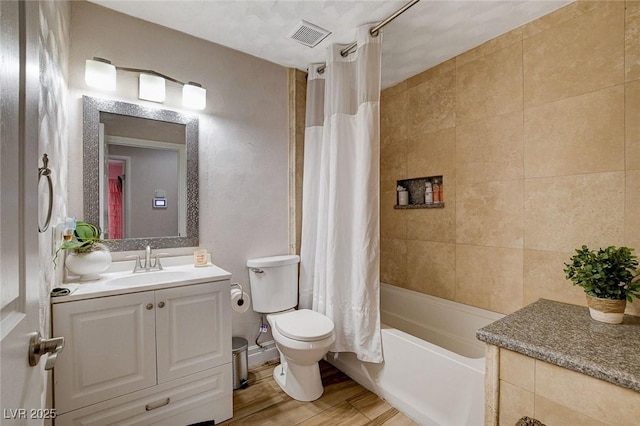 full bathroom with toilet, vanity, hardwood / wood-style floors, and shower / bathtub combination with curtain