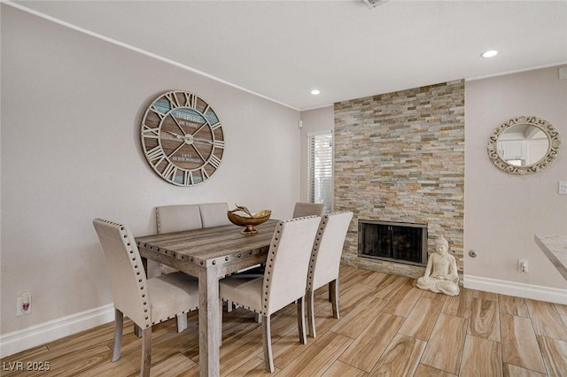 dining space with a stone fireplace