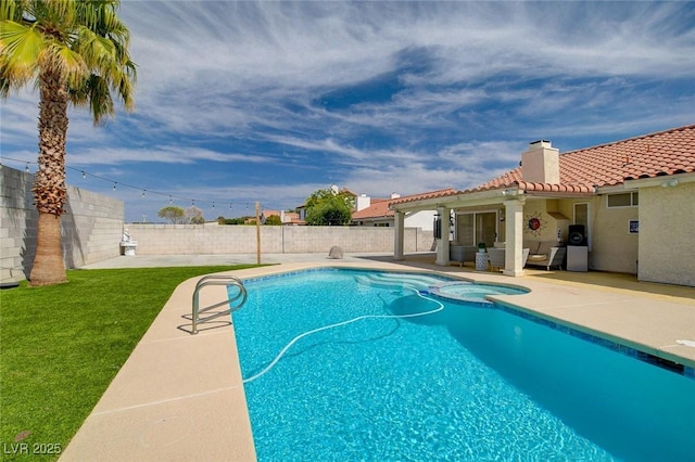 view of pool featuring a patio and an in ground hot tub