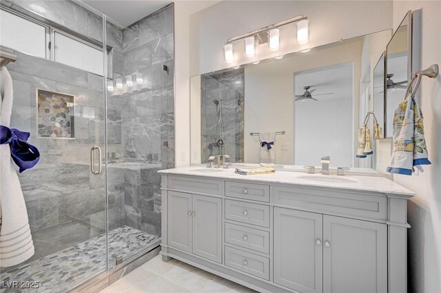 bathroom featuring a shower with door, ceiling fan, tile patterned floors, and vanity