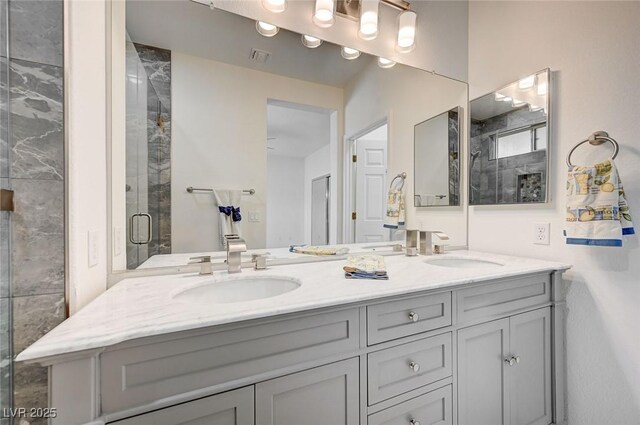 bathroom with walk in shower and vanity